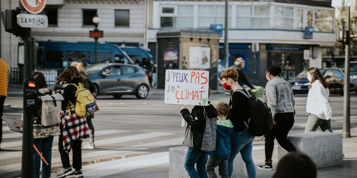 Paris street with children carrying climate posters