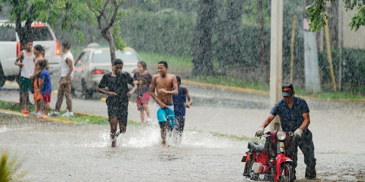 People  in downpour and flooded streets