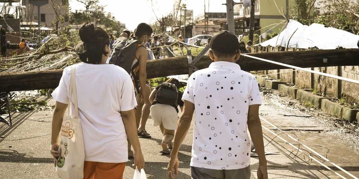 Philippines typhoon survivors walking in storm aftermath