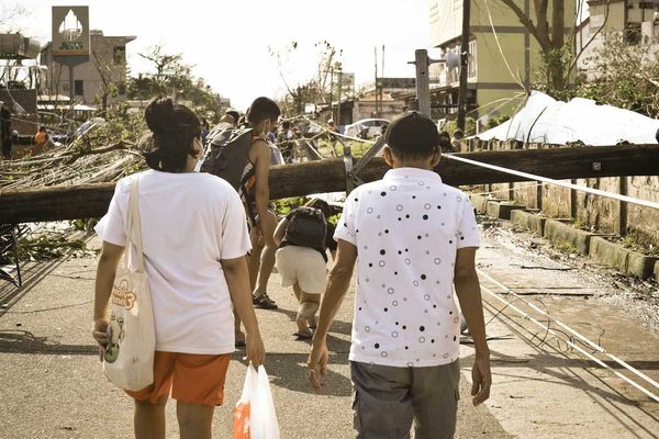 Philippines typhoon survivors walking in storm aftermath