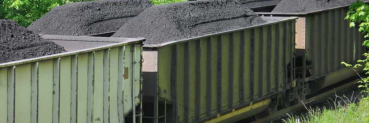 Piles of coal in open railroad cars
