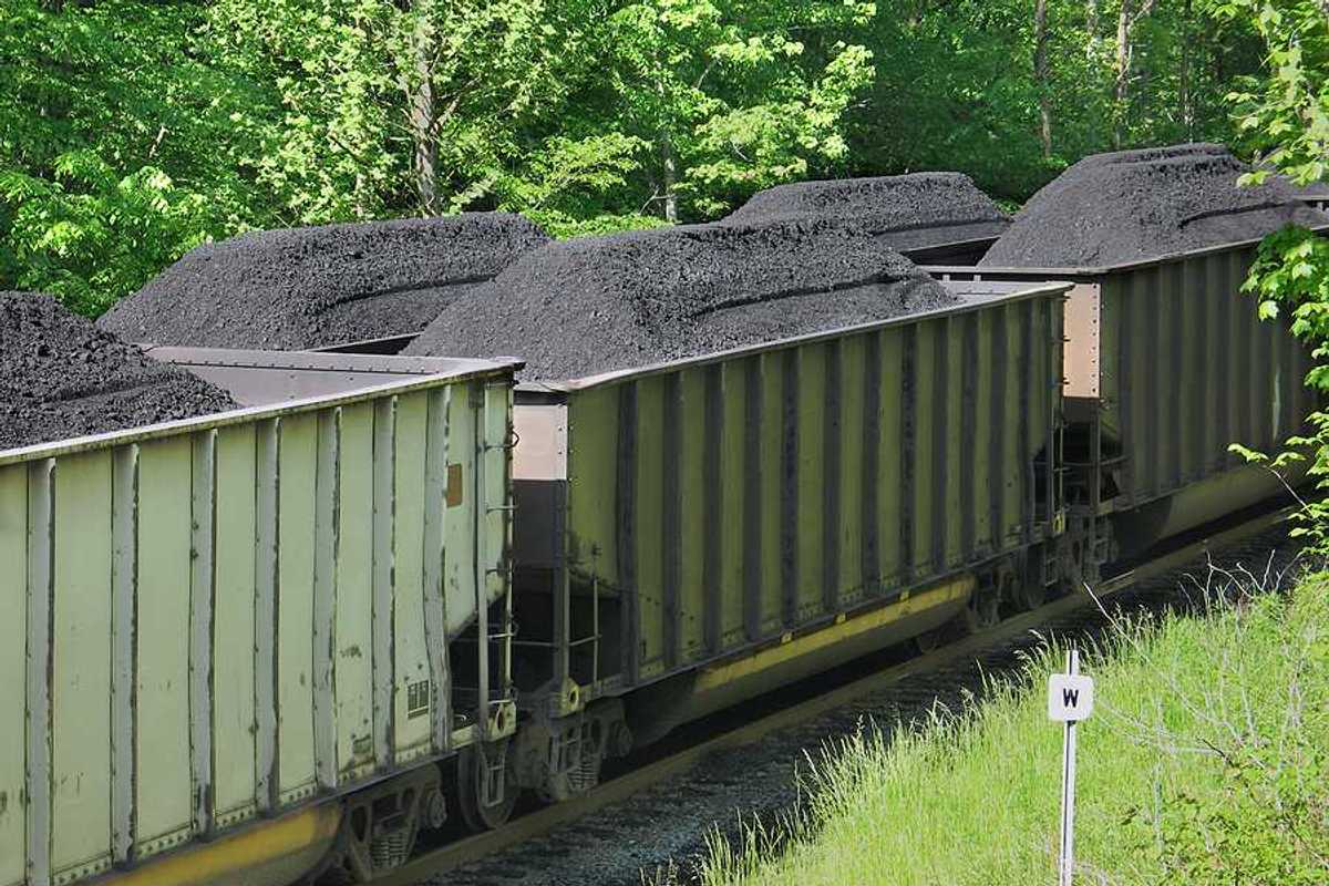 Piles of coal in open railroad cars