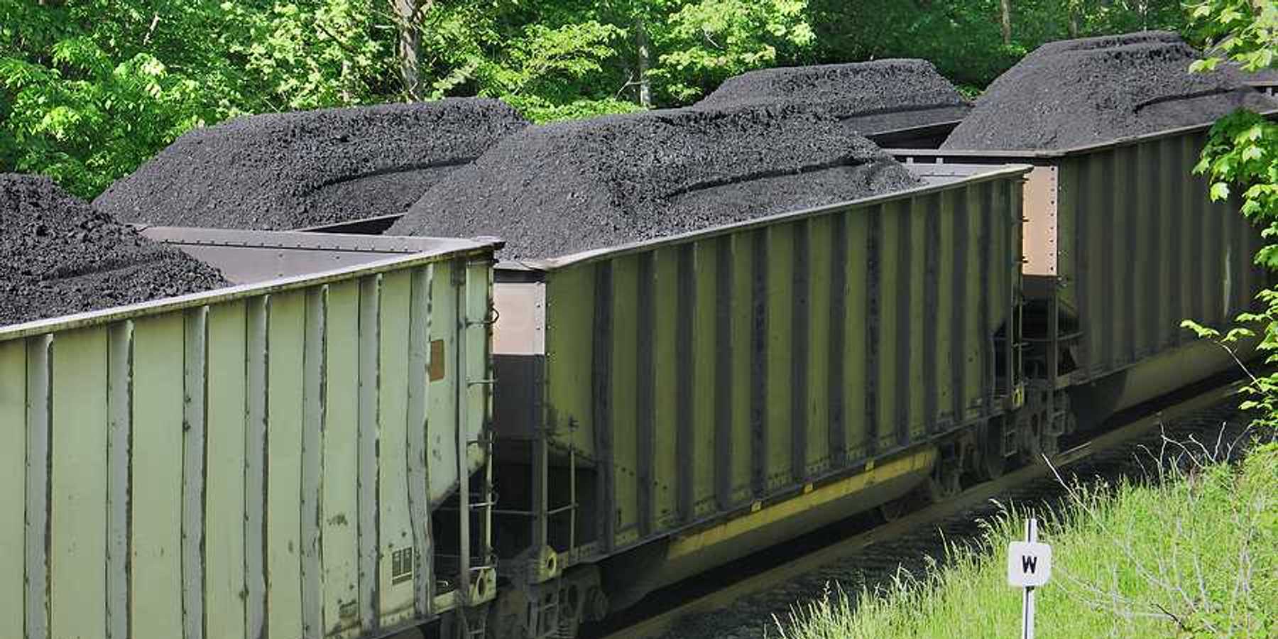 Piles of coal in open railroad cars