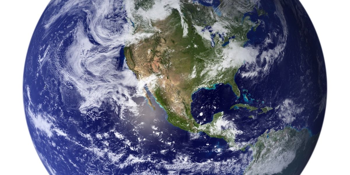 Planet Earth as seen from space with continents shrouded in clouds.
