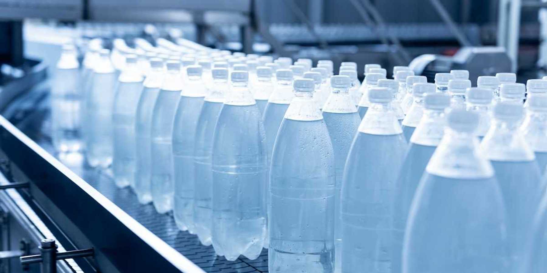 Plastic beverage bottles on an assembly line conveyor