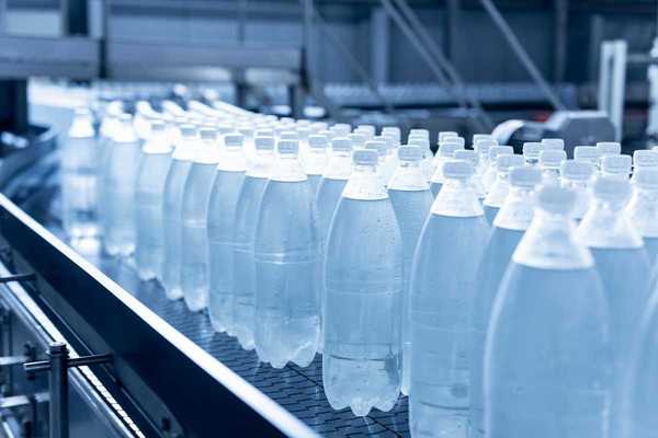 Plastic beverage bottles on an assembly line conveyor