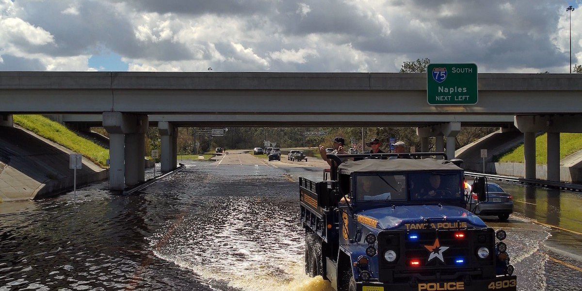 Police rescue truck driving through flood water in Florida