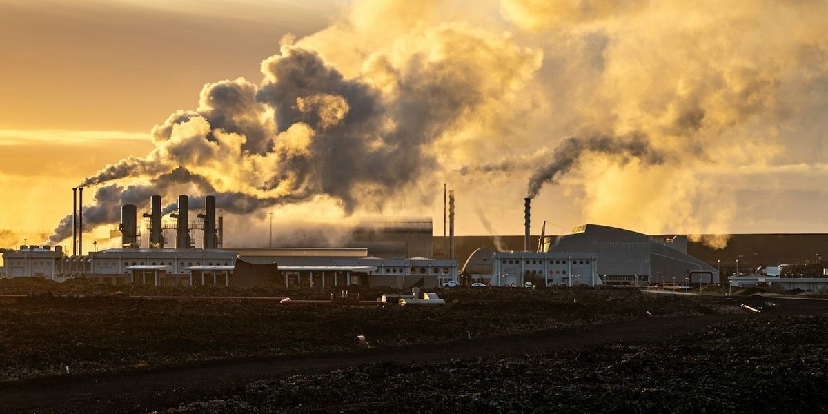 Polluting smoke billows from smokestacks of a power plant.