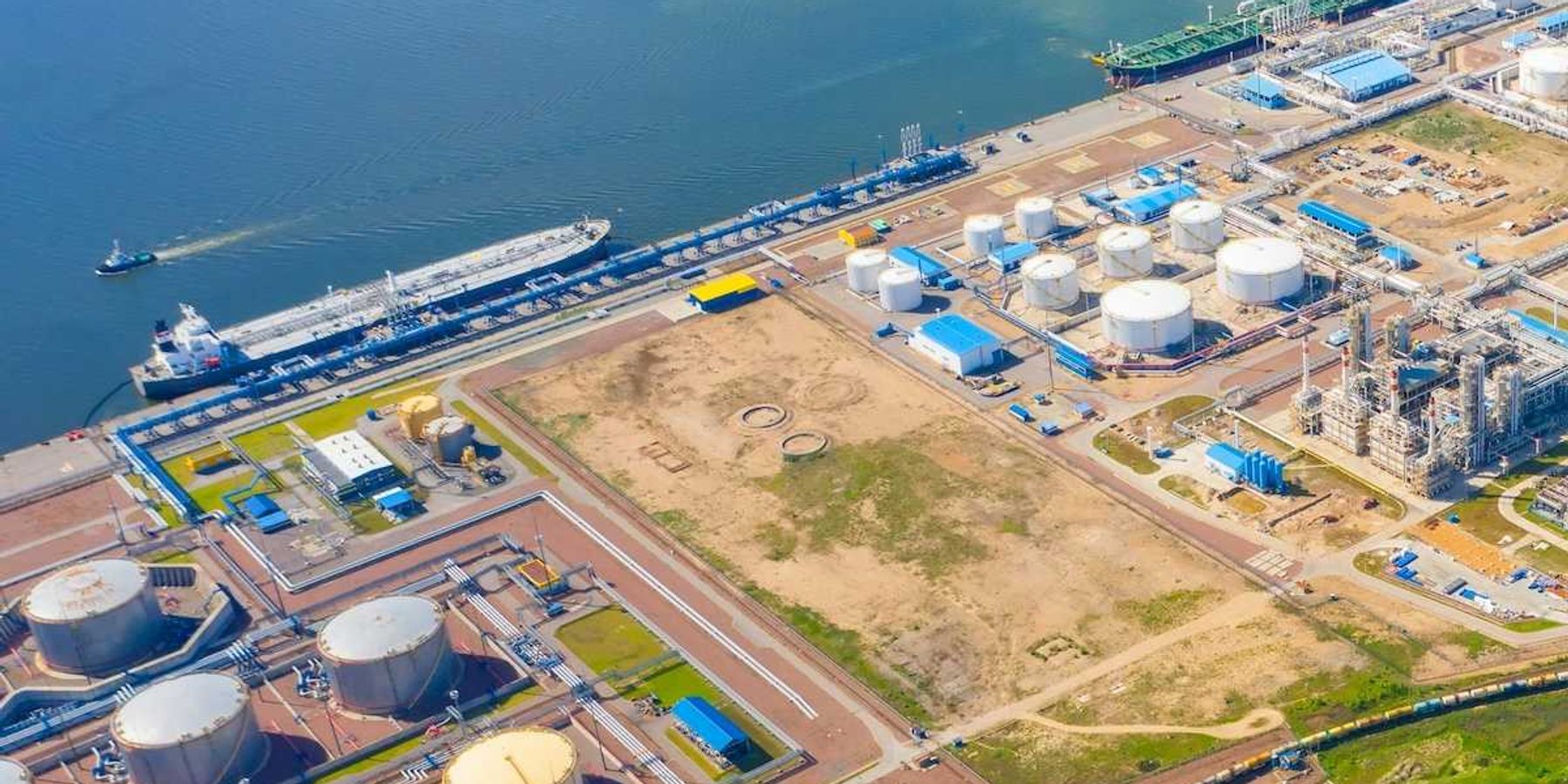 port refinery and petrochemical storage tanks adjacent to ocean