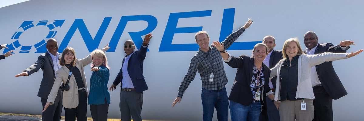 Posing as a wind turbine blade with National Renewable Energy Laboratory (NREL) and Department of Energy (DOE) staff