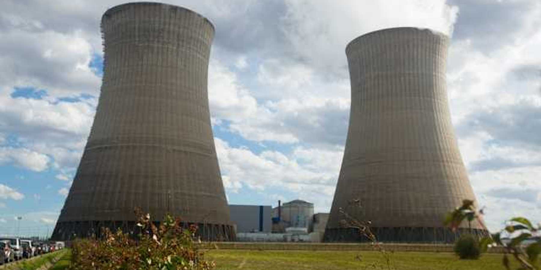 power plant towers with smoke emitting from the top
