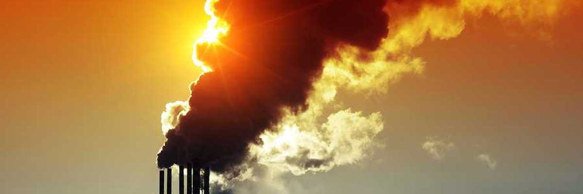 Power plant with smoke and dirty orange air.