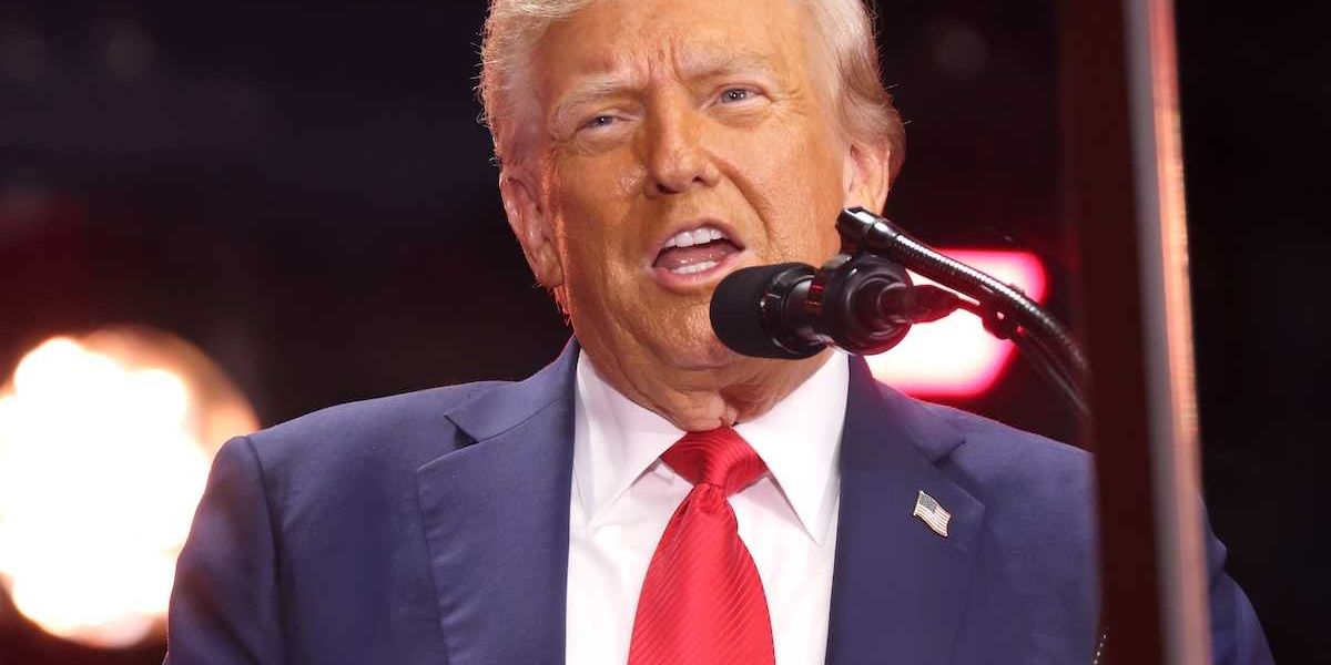President Donald Trump speaking into a microphone