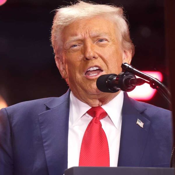 President Donald Trump speaking into a microphone