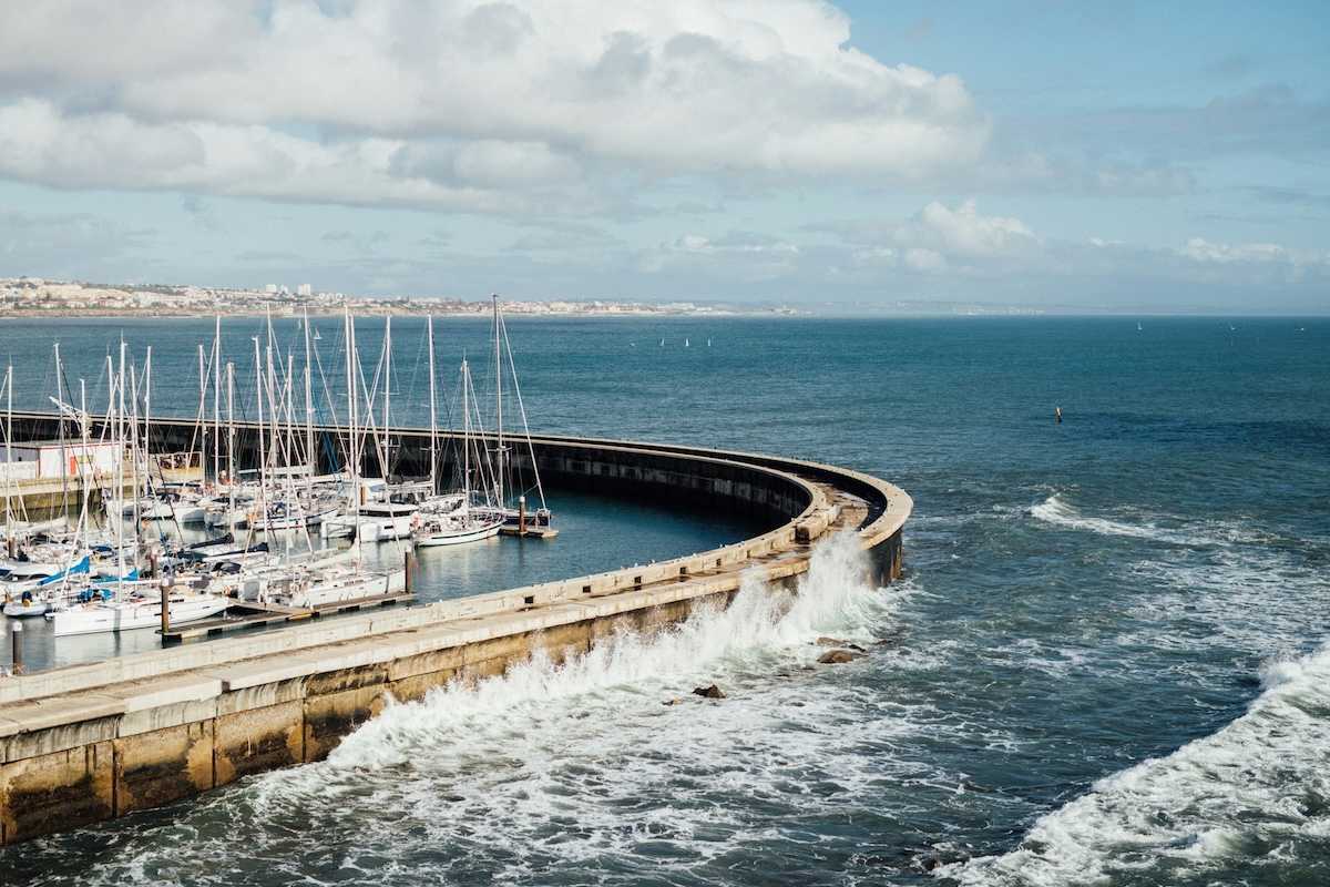 Protective sea wall sheltering multiple boats at harbor