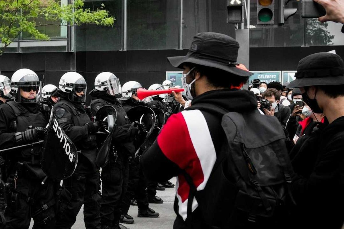Protesters face of with police on city street