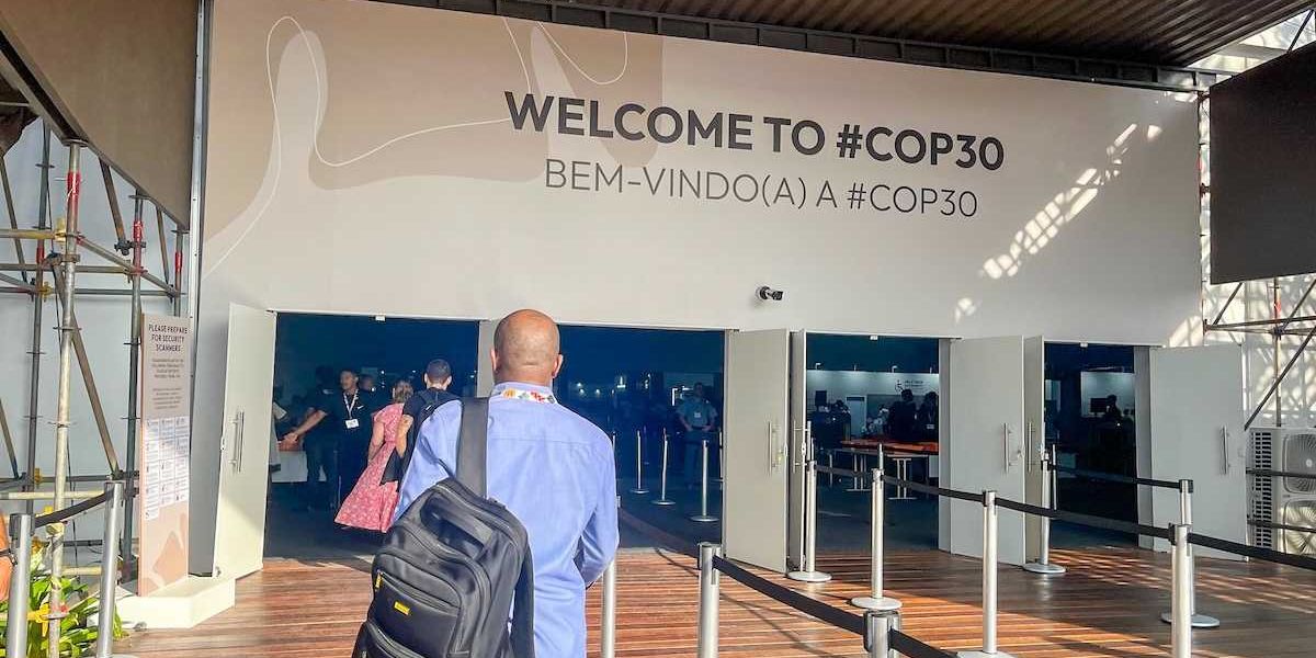 prticipants at the entrance to COP 30 pavilion