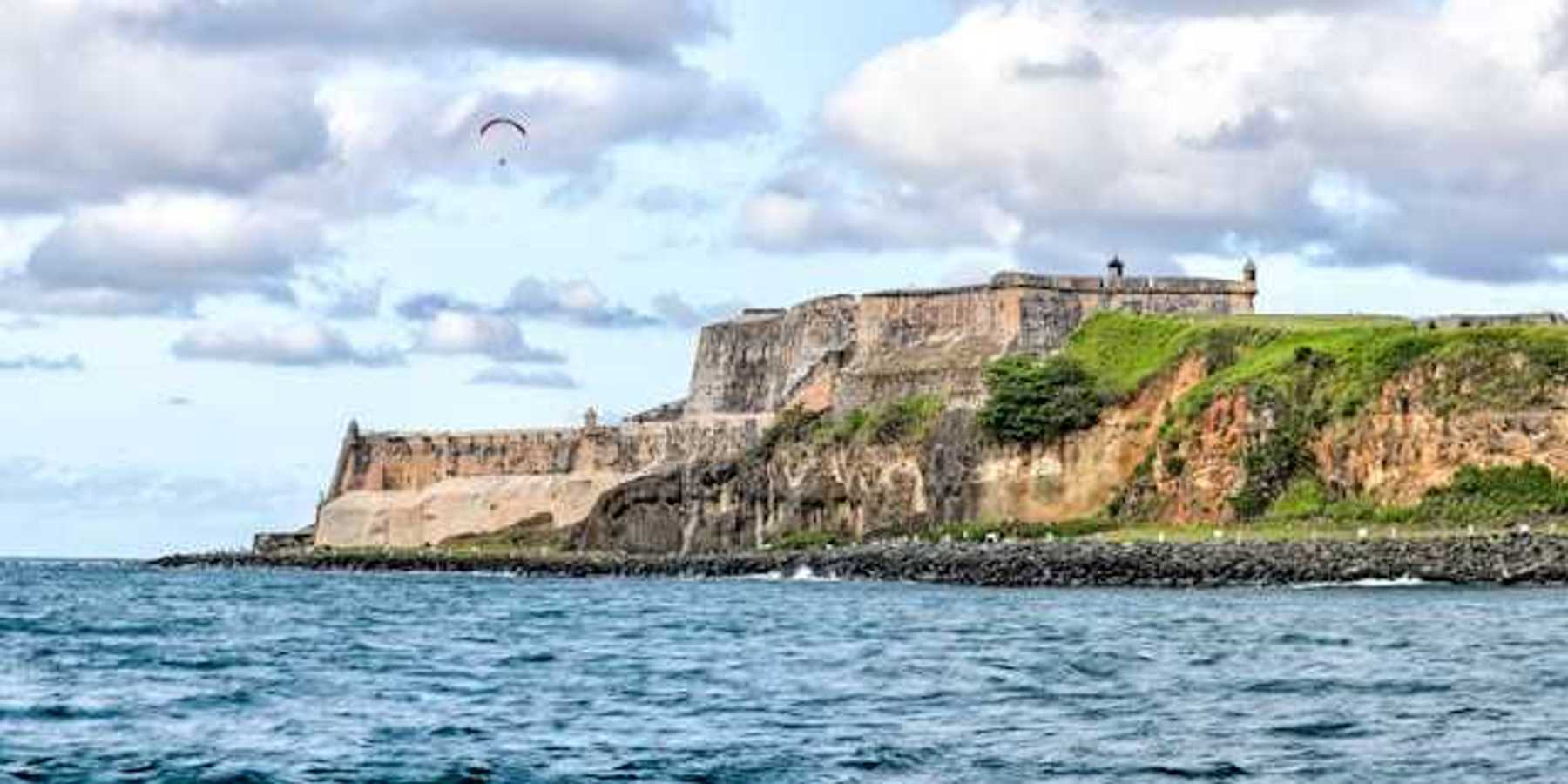 Puerto Rico's coastline with buildings that are ruins in the distance