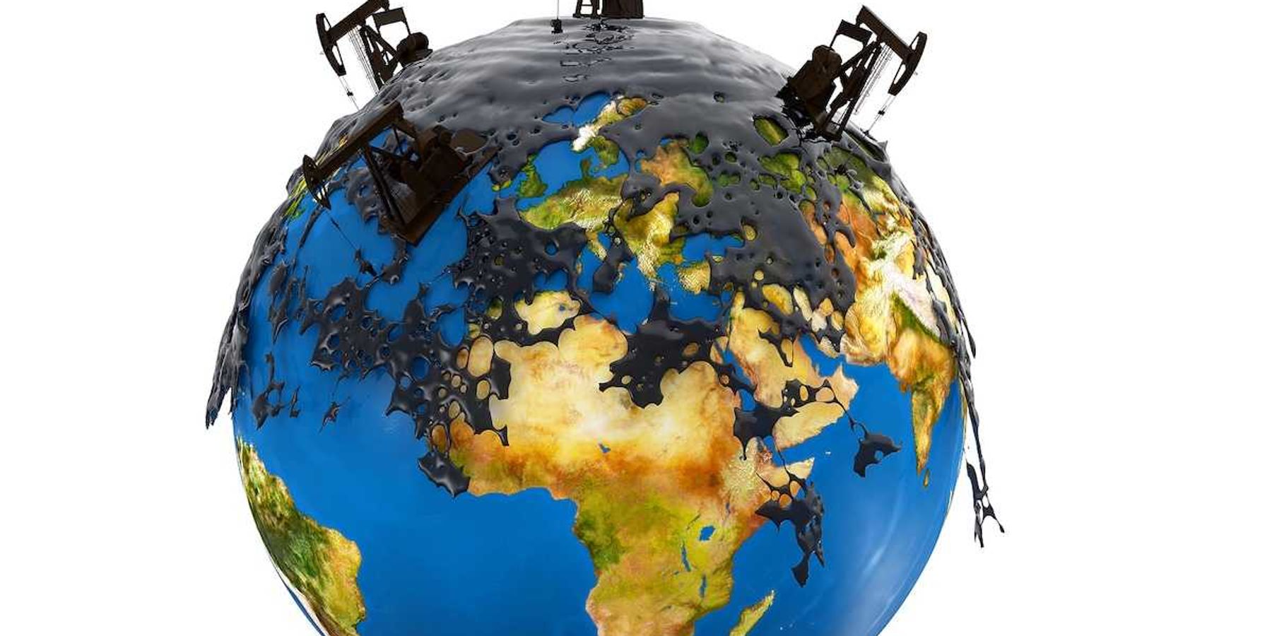 Pump jacks and oil spill over planet earth isolated on white background.