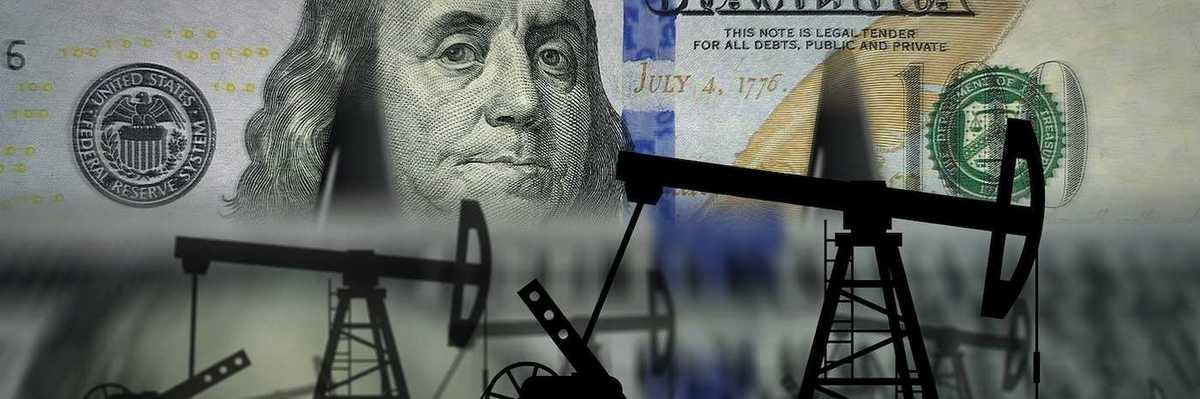 Pumpjacks and fuel business superimposed on US one hundred dollar bank note.