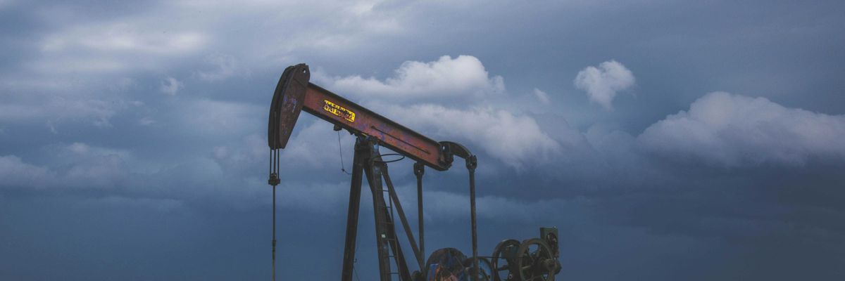 red and black heavy equipment on green grass field under white clouds during daytime