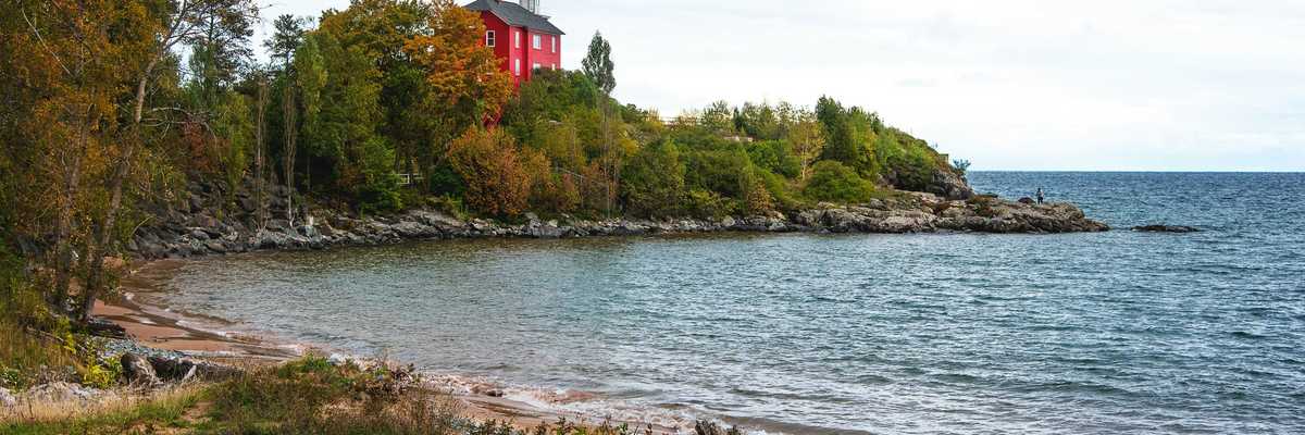 red and white building near body of water during daytime