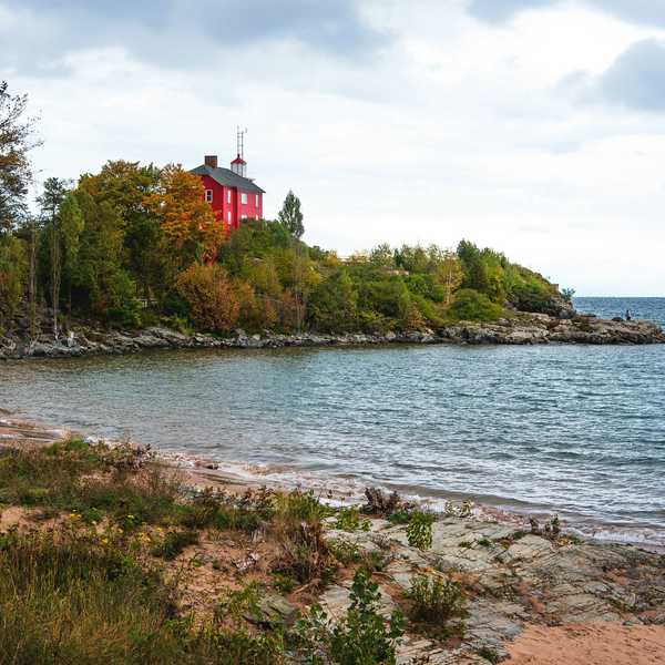 red and white building near body of water during daytime