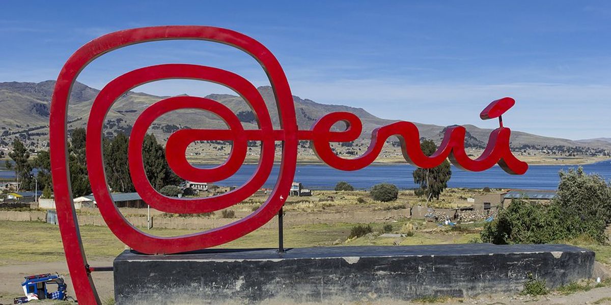Red sign saying Peru in front of a lake.