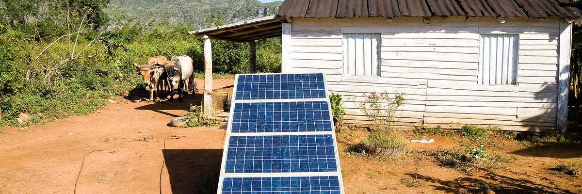Renewable energy in the Cuban countryside with small white domicile and an oxcart