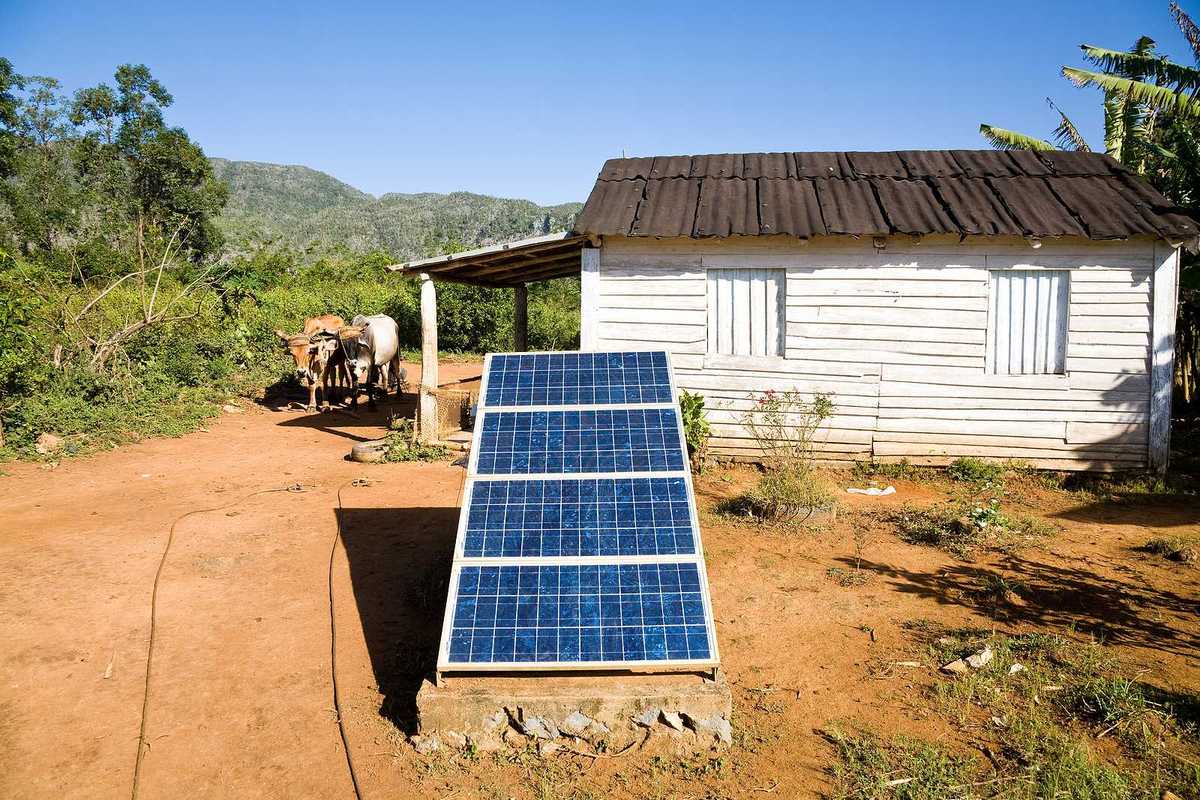 Renewable energy in the Cuban countryside with small white domicile and an oxcart