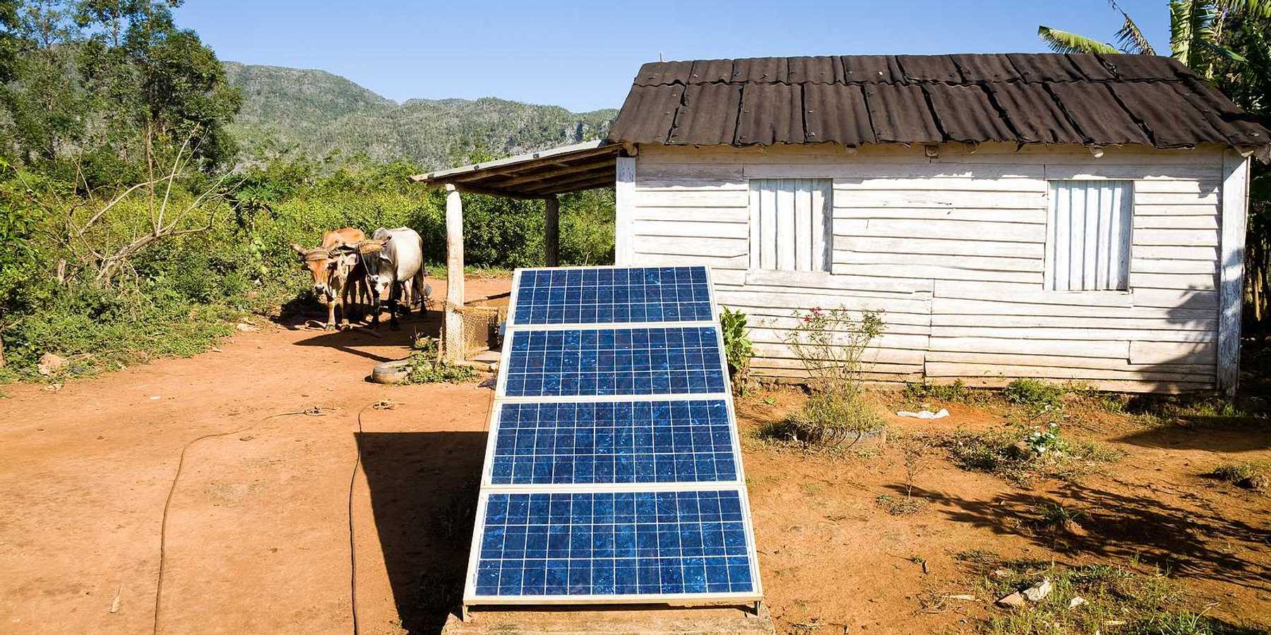 Renewable energy in the Cuban countryside with small white domicile and an oxcart