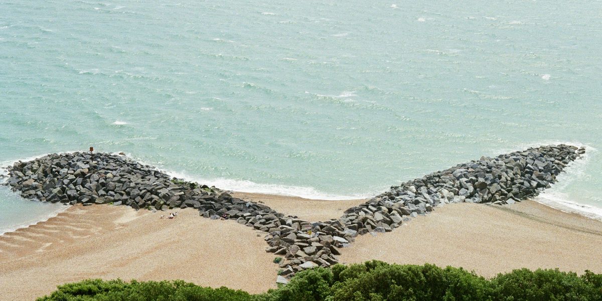 Rocks placed on a beach to reduce erosion.