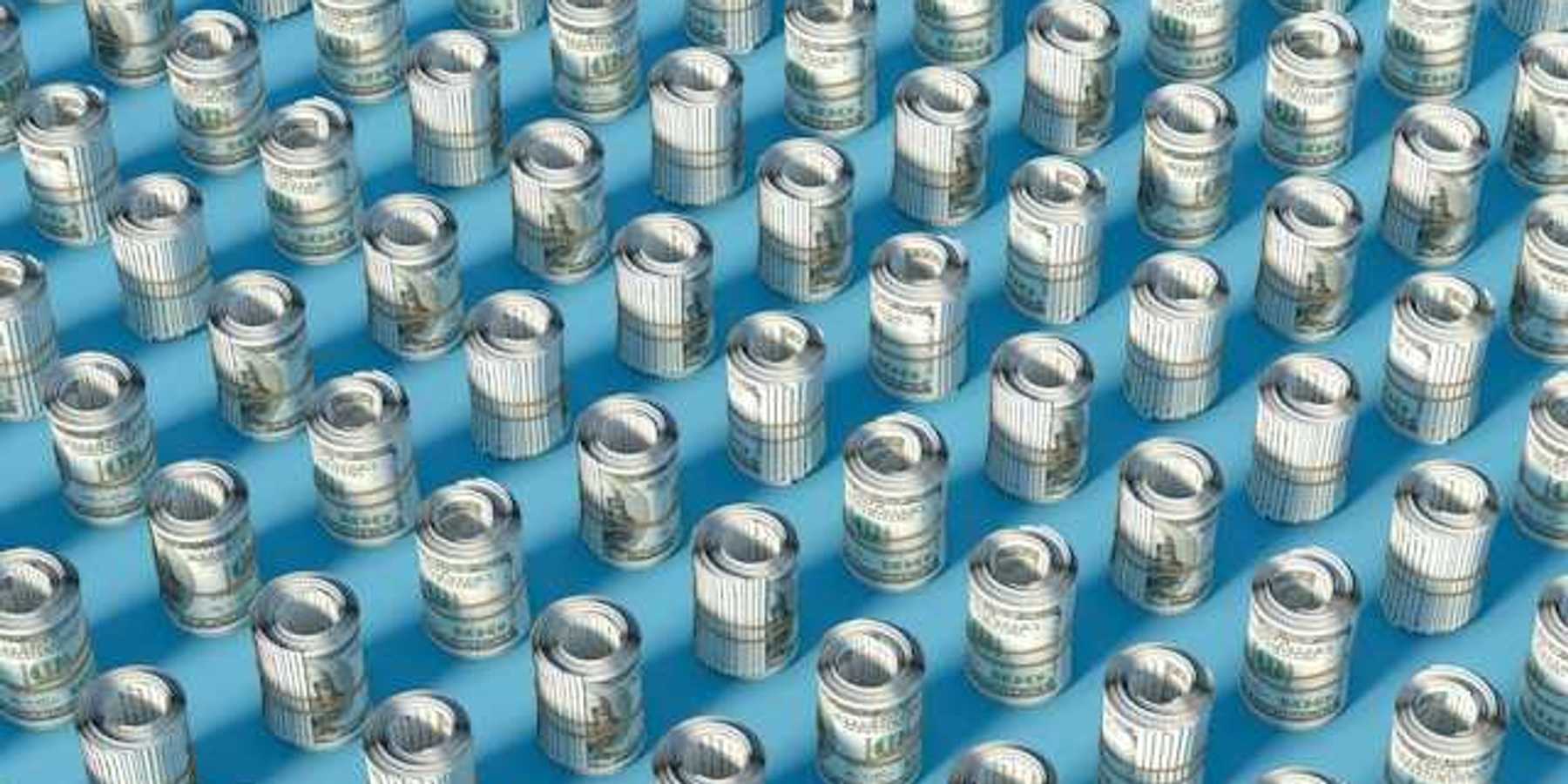 Rows of rolled up hundred-dollar U.S. bills on a blue surface