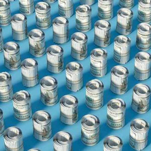 Rows of rolled up hundred-dollar U.S. bills on a blue surface