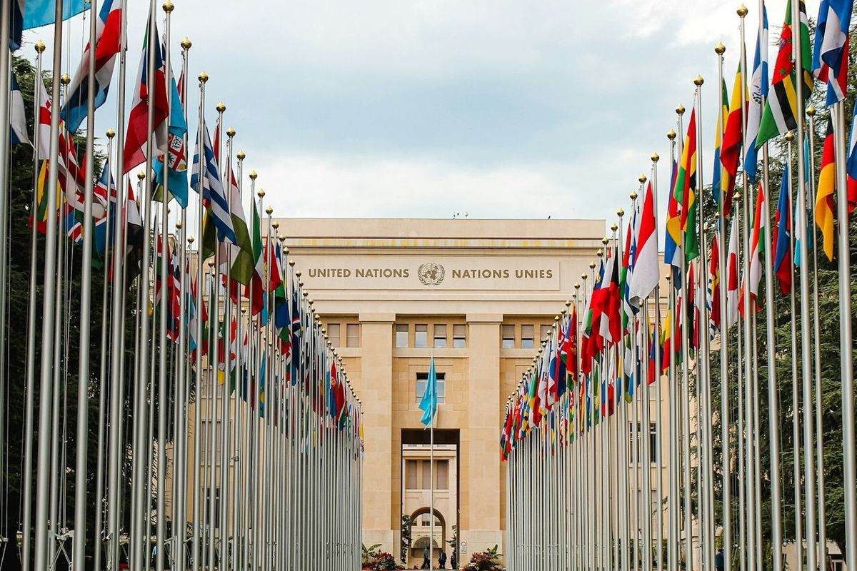 Rows of United Nations world flags outside UN building in Geneva, Switzerland.