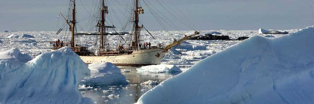 Sailing ship among the icebergs, Antarctica