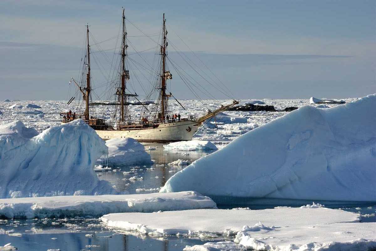 Sailing ship among the icebergs, Antarctica