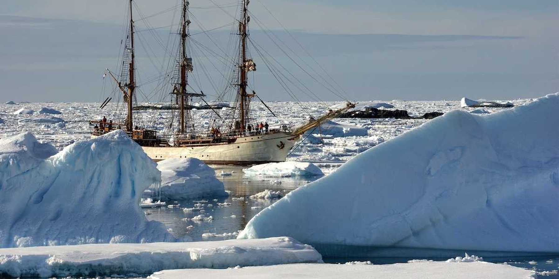 Sailing ship among the icebergs, Antarctica