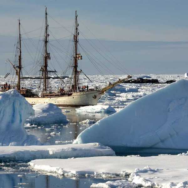 Sailing ship among the icebergs, Antarctica
