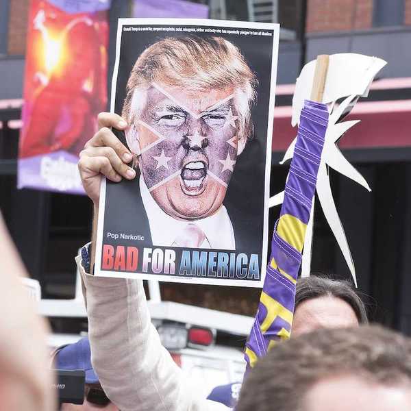 SAN DIEGO USA - MAY 27 2016: A protester holds a sign featuring an angry photo of Donald Trump and reading "Bad for America" at an anti-Trump protest outside a Trump rally in San Diego