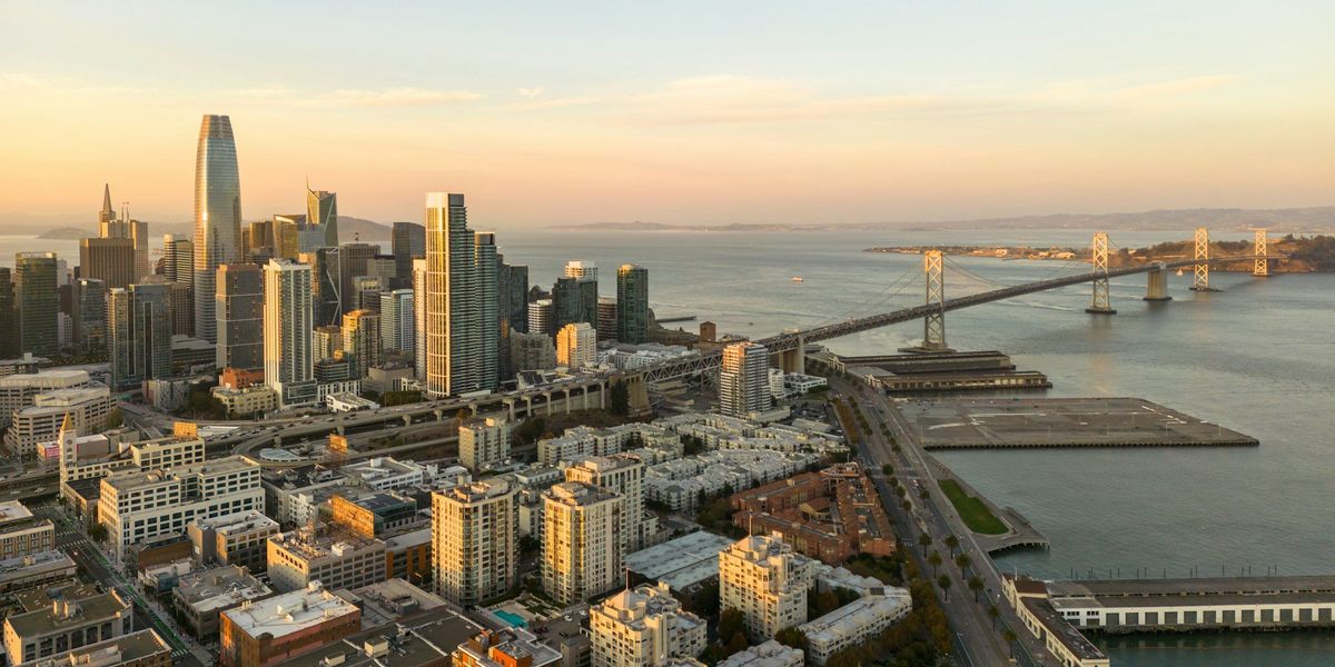 San Francisco skyline and bay spanned by a bridge.