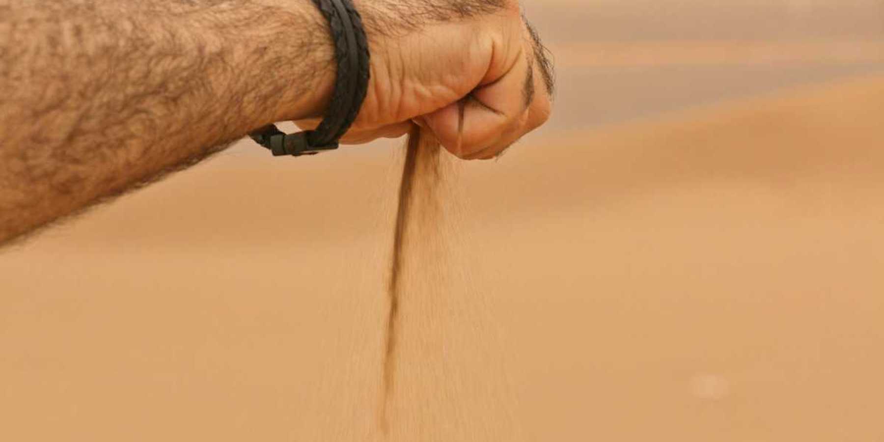 Sand sifting slowly through clenched hand.