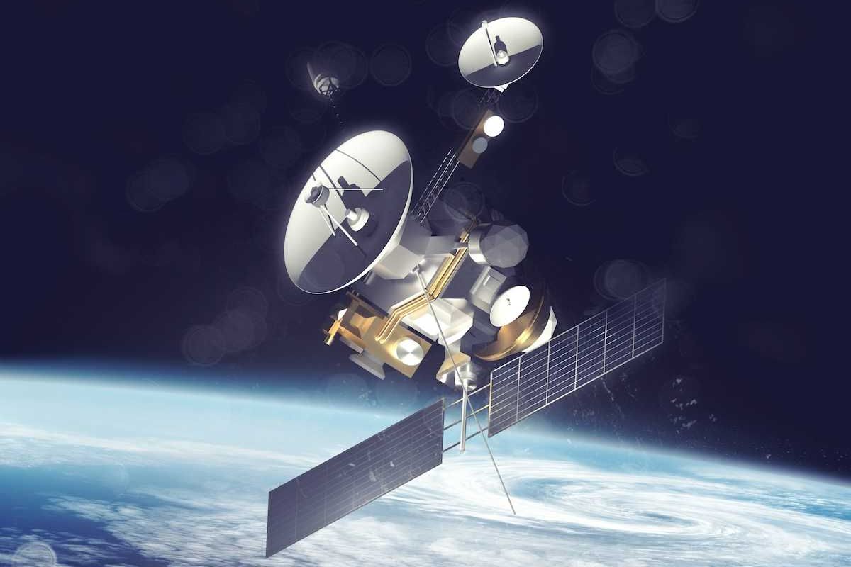 satellite with solar panels deployed over Earth