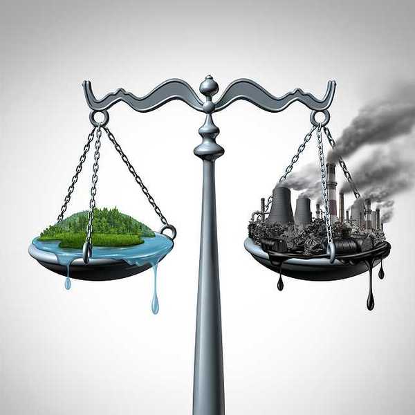 Scales of justice with a harmonious green ecosystem on one side and a dirty polluted fossil fuel plagued industrial site on the other scale
