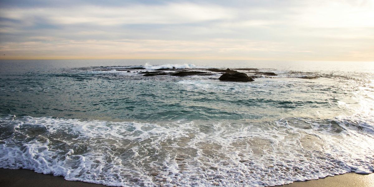 Sea waves crashing on seashore during daytime.