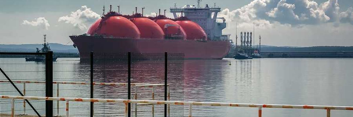 Ship and tugs are maneuvering at an LNG terminal