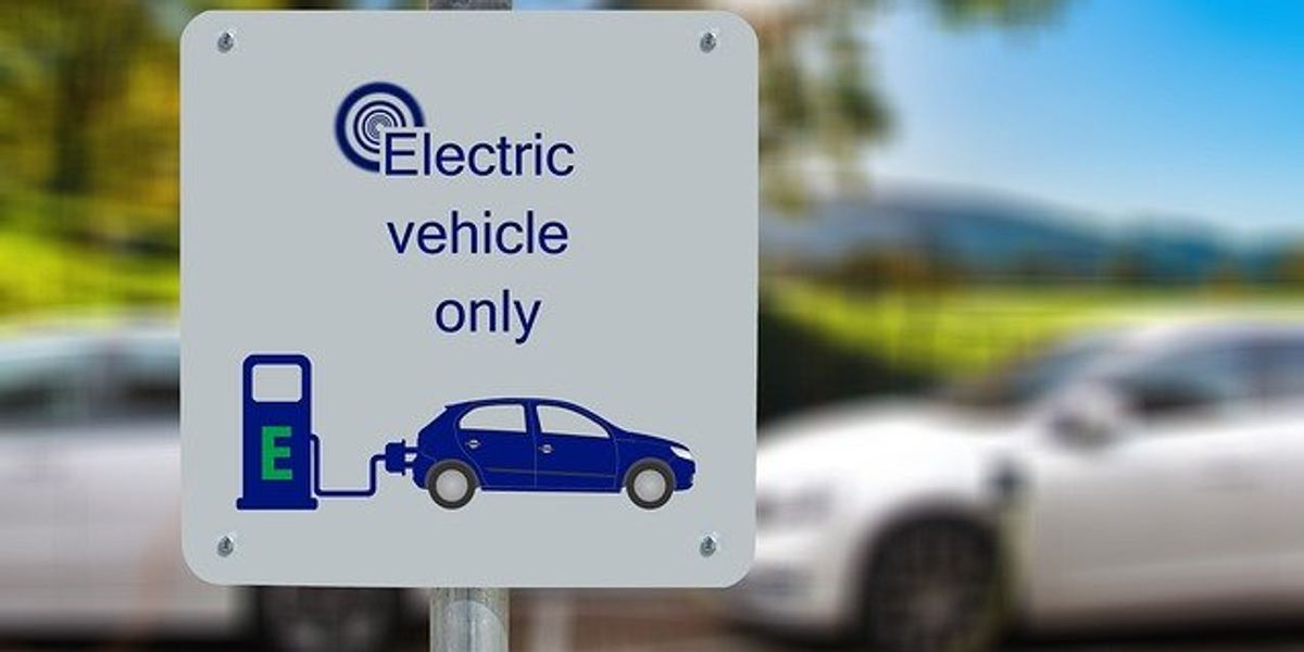Sign in front of electric vehicle chargers that says 'Electric Vehicle Only'.