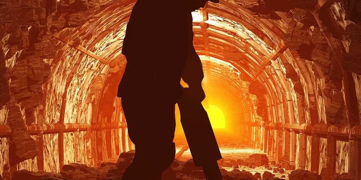Silhouette of worker in a mine tunnel