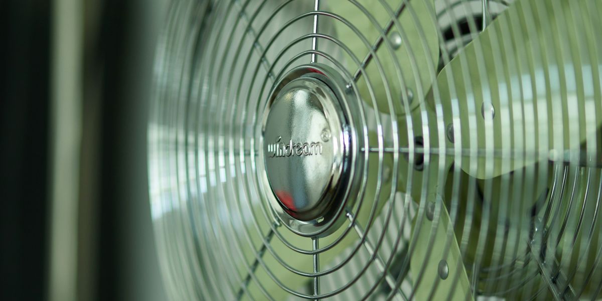 silver and black electric oscillating fan in close up photography.