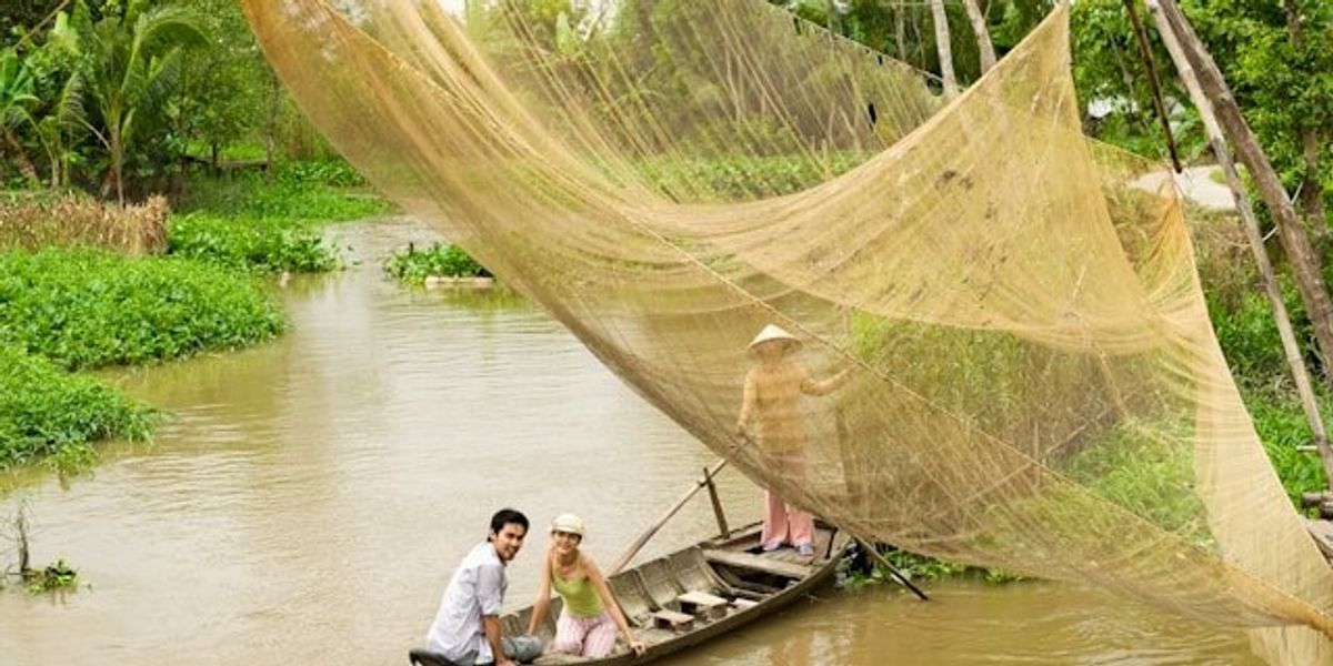 Small boat in an asian river with fishing nets.